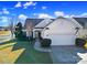 House exterior featuring a two-car garage and landscaped lawn at 2123 Hartwell Ln, Fort Mill, SC 29707