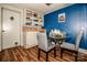 Small dining area with glass-top table and blue accent wall at 241 4Th N Ave, Taylorsville, NC 28681