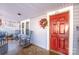 Red front door entry with rocking chairs on the porch at 241 4Th N Ave, Taylorsville, NC 28681
