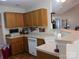 Kitchen with wood cabinets, white appliances and a breakfast bar at 4619 Brewington Pkwy # 4, Rock Hill, SC 29732