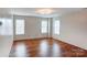 Bright bedroom with hardwood floors and multiple windows at 6071 Underwood Ave, Charlotte, NC 28213