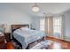 Relaxing main bedroom with hardwood floors and a large window at 6071 Underwood Ave, Charlotte, NC 28213