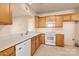 Kitchen with light wood cabinets and white appliances at 6327 Cherry Blossom Cir, Indian Land, SC 29707