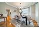 Bright dining room features a table with seating for six and hardwood floors at 6998 Ridgeway Rd, Stanley, NC 28164