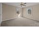 Bright bedroom with carpet flooring and two large windows at 10945 Caroline Acres Rd, Indian Land, SC 29707