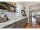 Gray kitchen cabinets and granite countertops with floating shelves at 112 Sisters Cove Ct, Mooresville, NC 28117