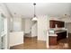 Kitchen with dark wood cabinets and a breakfast bar that opens to the dining room at 1282 Branson Nw Rd, Concord, NC 28027