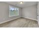 Well-lit bedroom with wood-look flooring and a window at 1308 Carmel Rd, Lancaster, SC 29720