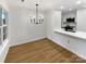Modern dining area with chandelier and kitchen bar at 5003 Sharon Rd # S, Charlotte, NC 28210