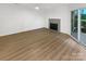Living room with fireplace and hardwood floors, showcasing natural light at 5003 Sharon Rd # S, Charlotte, NC 28210