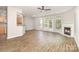 Living room with wood-look floors, a fireplace, and access to the patio at 5421 Waverly Lynn Ln, Charlotte, NC 28269