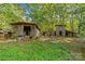Rustic outbuildings on wooded property at 5621 Mount Olive Church Rd, Charlotte, NC 28278