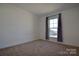 Well-lit bedroom featuring neutral walls and carpeting at 9029 Odell Corners Nw Blvd, Concord, NC 28027