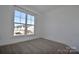 Bright bedroom with large window and neutral carpeting at 9029 Odell Corners Nw Blvd, Concord, NC 28027