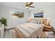 Virtually staged bedroom with wood bed frame and neutral color palette at 104 Abingdon Cir, Huntersville, NC 28078