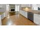 Kitchen with stone fireplace, white cabinets and tile flooring at 104 Abingdon Cir, Huntersville, NC 28078