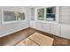 Bright sunroom with built-in shelving and hardwood floors at 104 Abingdon Cir, Huntersville, NC 28078