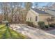 House exterior with driveway, landscaping, and storage shed at 10800 Honey Bee Cir, Charlotte, NC 28226