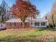 Brick ranch home with a large tree and landscaped yard at 1511 Anthony Dr, Gastonia, NC 28052