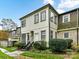 Beige two story condo with dark roof and landscaping at 1708 Roxborough Rd # E, Charlotte, NC 28211