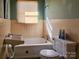 Bathroom with beige tile, a bathtub, and a sink at 1709 W Highway 27 Hwy, Lincolnton, NC 28092