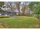 Landscaped backyard with fire pit and modern home at 1823 Bentley Pl, Charlotte, NC 28205