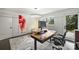 Bright home office with built-in desk and access to backyard at 1823 Bentley Pl, Charlotte, NC 28205