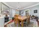 Bright dining room features a wood table, chandelier, and fireplace at 307 E 2Nd St, Lowell, NC 28098