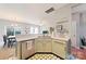 Well-equipped kitchen with light green cabinets, stainless steel appliances, and tiled floors at 3507 Summerfield Ridge Ln, Matthews, NC 28105