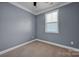 Simple bedroom with neutral walls and a window with blinds at 3657 Norman View Dr, Sherrills Ford, NC 28673