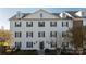 Three-story building exterior with multiple windows and neutral color scheme at 3867 Carl Parmer Dr, Harrisburg, NC 28075