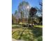 Front yard with trees and green grass under a sunny sky at 412 Cornerstone Dr, Taylorsville, NC 28681