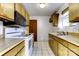 Efficient kitchen with wood cabinets and white appliances at 426 Gene Ave, Charlotte, NC 28205