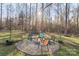 Fire pit area with seating in a wooded backyard setting at 4477 Pinebrook Dr, Rock Hill, SC 29730