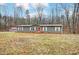 Gray single-wide manufactured home with red door, and storage shed on wooded lot at 5211 Timber Creek Ct, Kings Mountain, NC 28086