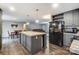 Open kitchen with island, stainless steel appliances, and gray cabinets at 5211 Timber Creek Ct, Kings Mountain, NC 28086