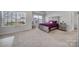 Spacious primary bedroom with carpeted floor and large windows at 654 Lancelot Dr, Richburg, SC 29729