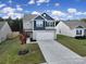Two-story house with gray and blue siding, two-car garage, and landscaped lawn at 654 Lancelot Dr, Richburg, SC 29729