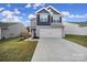Two-story house with gray and blue siding, two-car garage, and landscaped lawn at 654 Lancelot Dr, Richburg, SC 29729