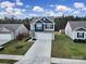 Two-story home with gray siding, navy blue accents, and a two car garage at 654 Lancelot Dr, Richburg, SC 29729