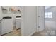 Convenient laundry room with washer, dryer and overhead shelving at 654 Lancelot Dr, Richburg, SC 29729