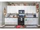 Modern kitchen featuring white cabinets, granite countertops, and a black stove at 685 Goldflower Dr, Rock Hill, SC 29732