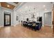 Modern kitchen with island, stainless steel appliances, and herringbone floors at 7313 Mockingbird Ln, Waxhaw, NC 28173