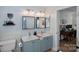 Double vanity bathroom with a large mirror and built-in shelving at 12128 Robins Nest Ln, Charlotte, NC 28269