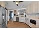 Galley kitchen with stainless steel appliances and white cabinets at 12128 Robins Nest Ln, Charlotte, NC 28269