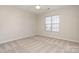 Spacious bedroom featuring carpeted floors and a large window at 1414 Kronas Cir, Waxhaw, NC 28173