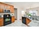 Kitchen with granite counters, wooden cabinets and black appliances at 1414 Kronas Cir, Waxhaw, NC 28173