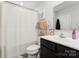 Clean bathroom with dark wood vanity, white shower, and neutral decor at 2409 Fathom Way, Charlotte, NC 28269