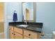 Small bathroom with light blue walls, granite countertop, and a single sink at 2534 Old Ashworth Nw Ln, Concord, NC 28027