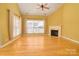 Bright living room with hardwood floors, fireplace, and large windows at 2534 Old Ashworth Nw Ln, Concord, NC 28027